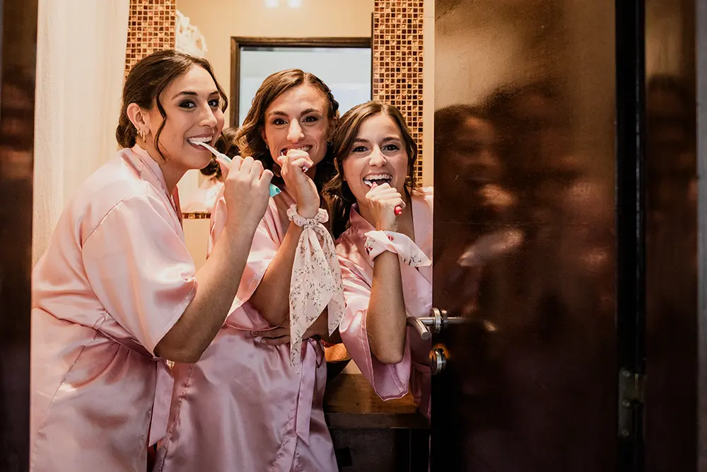 Amigas de la novia se lavan los dientes antes de salir